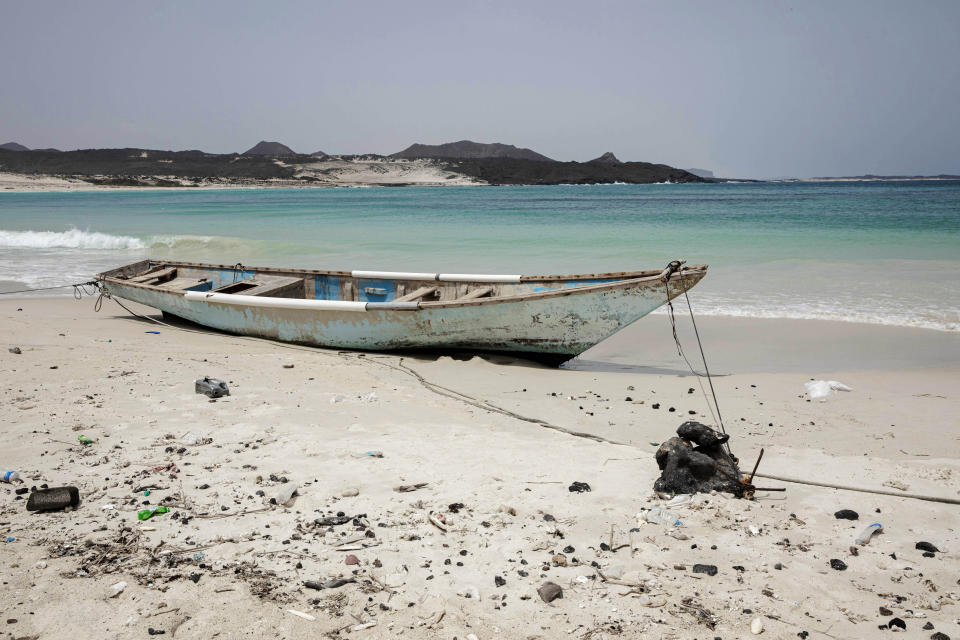 This July 27, 2019 photo shows a boat docked on the shores of Bir Ali, where migrants from Bosaso, Somalia arrive, in Shabwa, Yemen. Las Anoud, isolated in Somalia's deserts, the town is the hub for traffickers transporting Ethiopians to Yemen. It is also a center for brutal torture, according to multiple migrants. (AP Photo/Nariman El-Mofty)