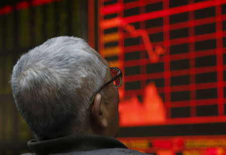 A man looks at an electronic board showing stock information at a brokerage house in Beijing, China, January 4, 2016. REUTERS/Kim Kyung-Hoon