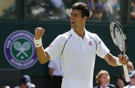 Novak Djokovic of Serbia celebrates after winning his match against Philipp Kohlschreiber of Germany at the Wimbledon Tennis Championships in London, June 29, 2015. REUTERS/Suzanne Plunkett