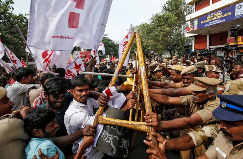 Police officers stop demonstrators during a protest against a new citizenship law, in Chennai