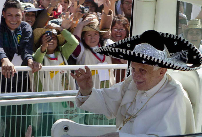 FILE - Pope Benedict XVI waves from the popemobile wearing a Mexican sombrero as he arrives to give a Mass in Bicentennial Park near Silao, Mexico, on March 25, 2012. Pope Emeritus Benedict XVI, the German theologian who will be remembered as the first pope in 600 years to resign, has died, the Vatican announced Saturday. He was 95. (AP Photo/Eduardo Verdugo, File)