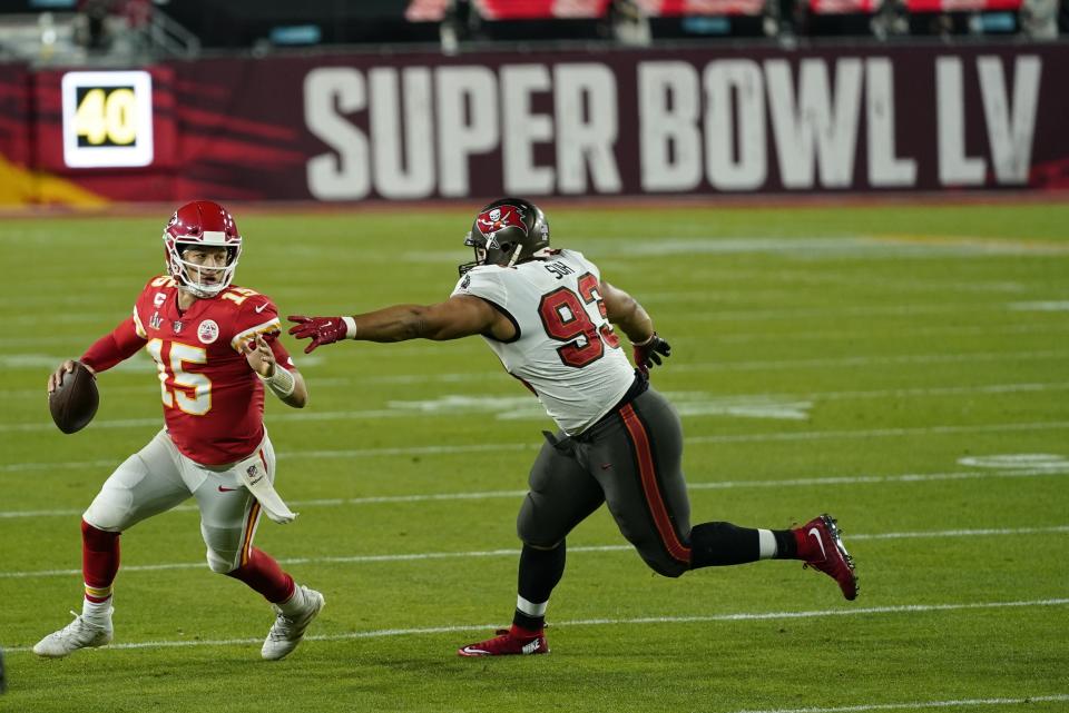 Tampa Bay Buccaneers defensive end Ndamukong Suh tries to tackle Kansas City Chiefs quarterback Patrick Mahomes during the second half of the NFL Super Bowl 55 football game Sunday, Feb. 7, 2021, in Tampa, Fla. (AP Photo/Mark Humphrey)