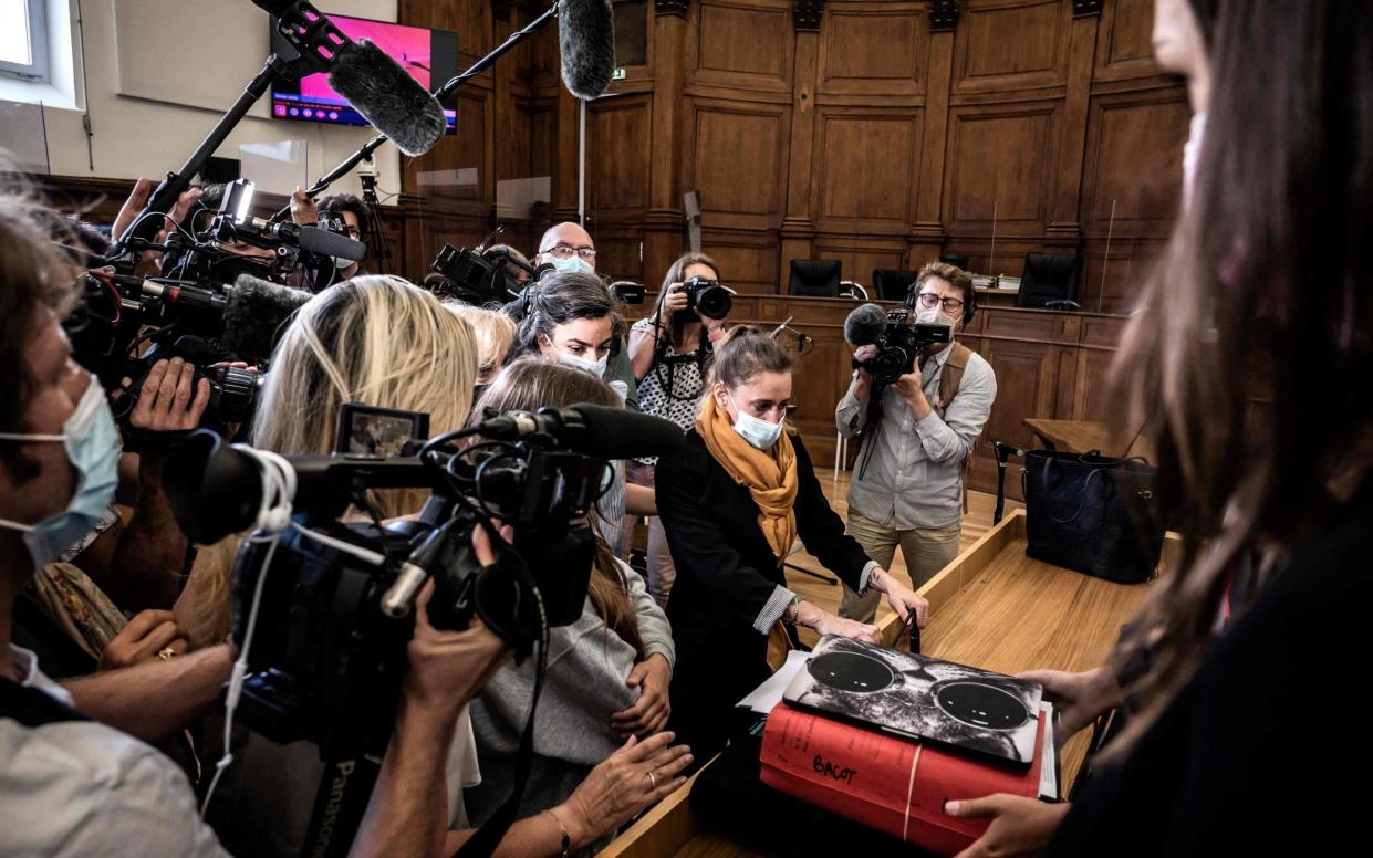 Valerie Bacot arrives in court flanked by her family and surrounded by journalists - JEFF PACHOUD/AFP via Getty Images