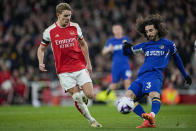 Arsenal's Martin Odegaard, left, tries to block a shot from Chelsea's Marc Cucurella during the English Premier League soccer match between Arsenal and Chelsea at Emirates Stadium in London, Tuesday, April 23, 2024. (AP Photo/Kin Cheung)