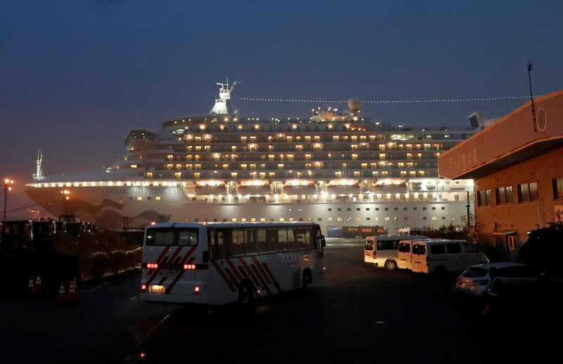 A bus arrives at the cruise ship Diamond Princess at Daikoku Pier Cruise Terminal in Yokohama