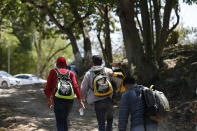 Migrants walk into Mexico after crossing the Usumacinta River from Guatemala, in Frontera Corozal, Chiapas state, Mexico, Wednesday, March 24, 2021. (AP Photo/Eduardo Verdugo)