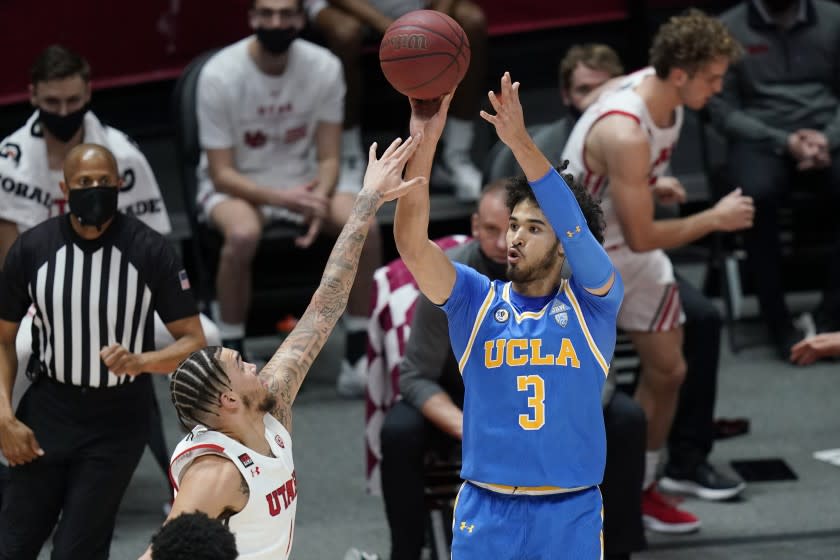 UCLA guard Johnny Juzang (3) shoots as Utah forward Timmy Allen, left, defends.