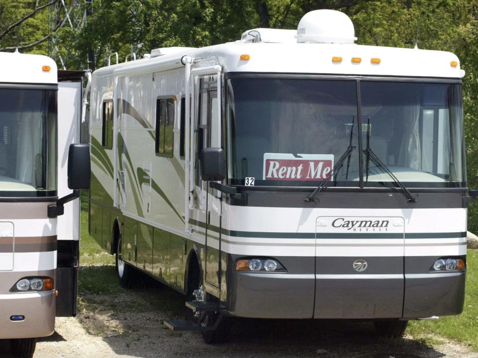 An RV with a sign that reads "Rent Me" on the dash.