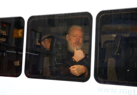 WikiLeaks founder Julian Assange is seen in a police van after was arrested by British police outside the Ecuadorian embassy in London, Britain April 11, 2019. REUTERS/Henry Nicholls