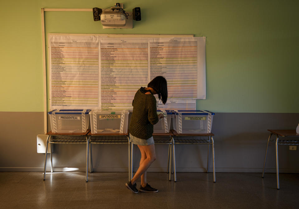 A woman casts her ballot at a polling station during presidential elections in Santiago, Chile, Sunday, Nov. 21, 2021. (AP Photo/Esteban Felix)