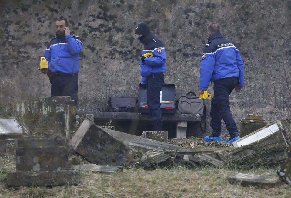 French gendarmes investigate near desecrated tombstones at the Sarre-Union Jewish cemetery, eastern France