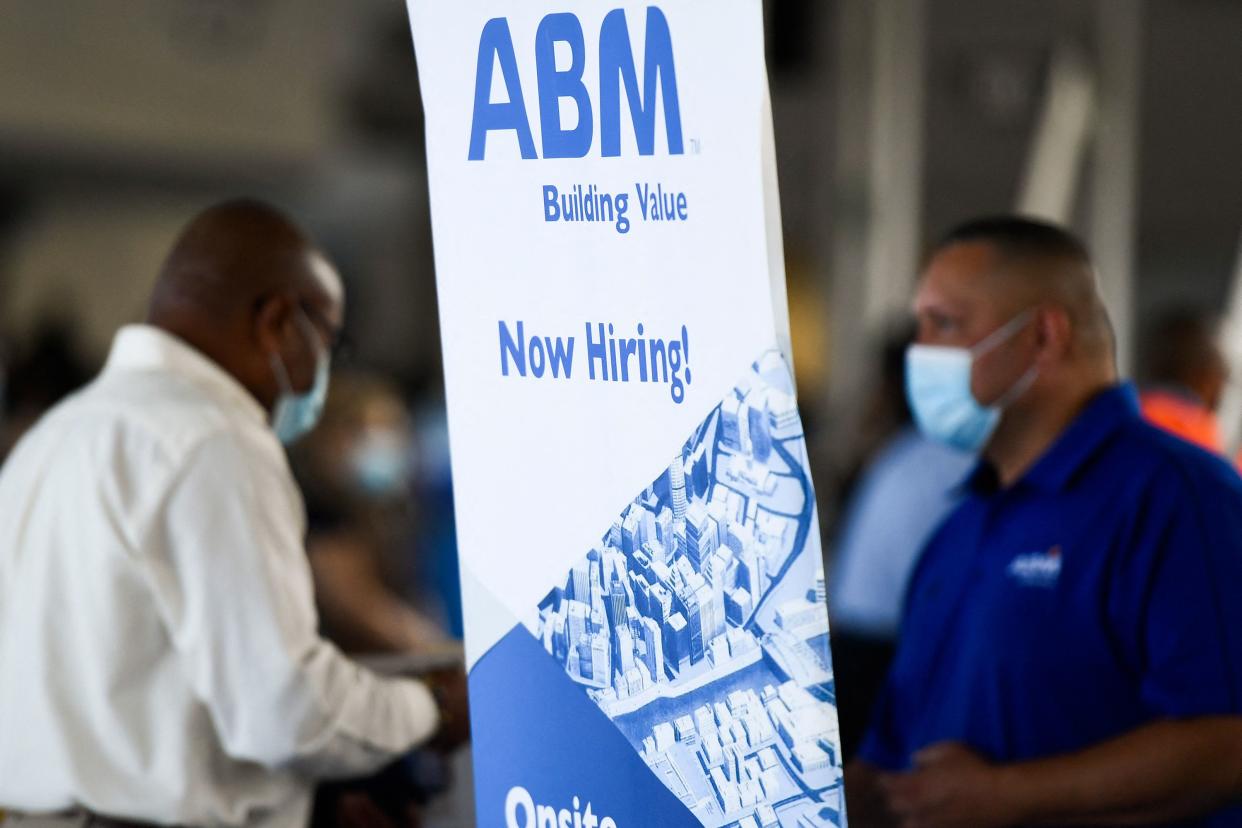 ABM Industries Inc. hiring announcement is posted as people attend a job fair for employment with SoFi Stadium and Los Angeles International Airport employers, at SoFi Stadium on September 9, 2021.