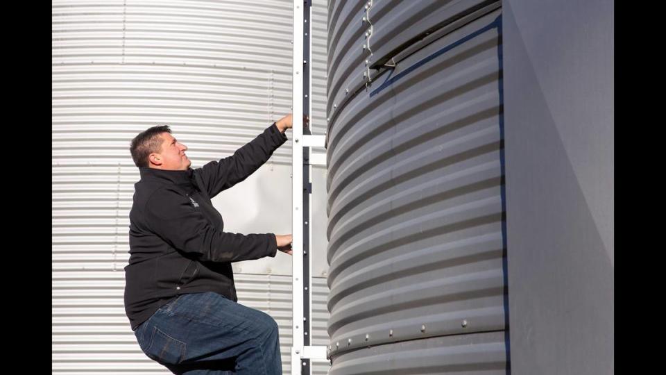 Chris Otten checks the moisture levels of his corn crop, stored in bins while they wait to be sold, on Monday, Dec. 18, 2023, at his farm outside St. Libory, Ill. For the third time in five years, the U.S. will import more agricultural products than it exports. However, this year’s deficit is tracking to be around $20 billion, far more than last year’s $2 billion deficit.