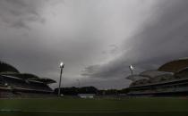 Storm clouds gather above the stadium during the fourth day's play in the second Ashes cricket test between England and Australia at the Adelaide Oval December 8, 2013. REUTERS/David Gray (AUSTRALIA - Tags: SPORT CRICKET)