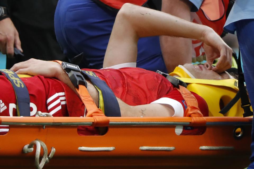 Paramedics carry on a stretcher Russia's Mario Fernandes after his injuring during the Euro 2020 soccer championship group B match between Russia and Finland at the Saint Petersburg stadium, in St. Petersburg, Russia, Wednesday, June 16, 2021. (Evgenia Novozhenina/Pool via AP)