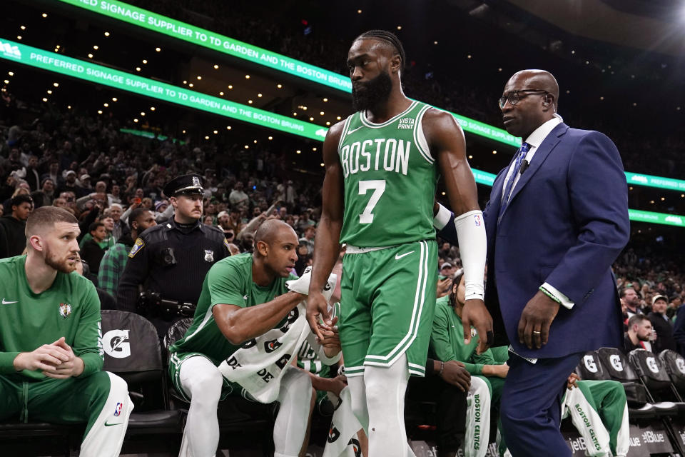 Boston Celtics guard Jaylen Brown (7) is escorted by a security official after being ejected during the second half of an NBA basketball game against the New York Knicks, Friday, Dec. 8, 2023, in Boston. (AP Photo/Charles Krupa)