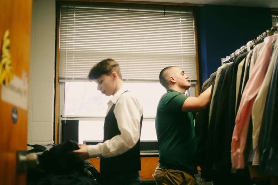 First generation college student Gage Farris helps arrange clothing for a clothes pantry on campus on Friday, March 15, 2024 at the University of Memphis in Memphis, Tenn.