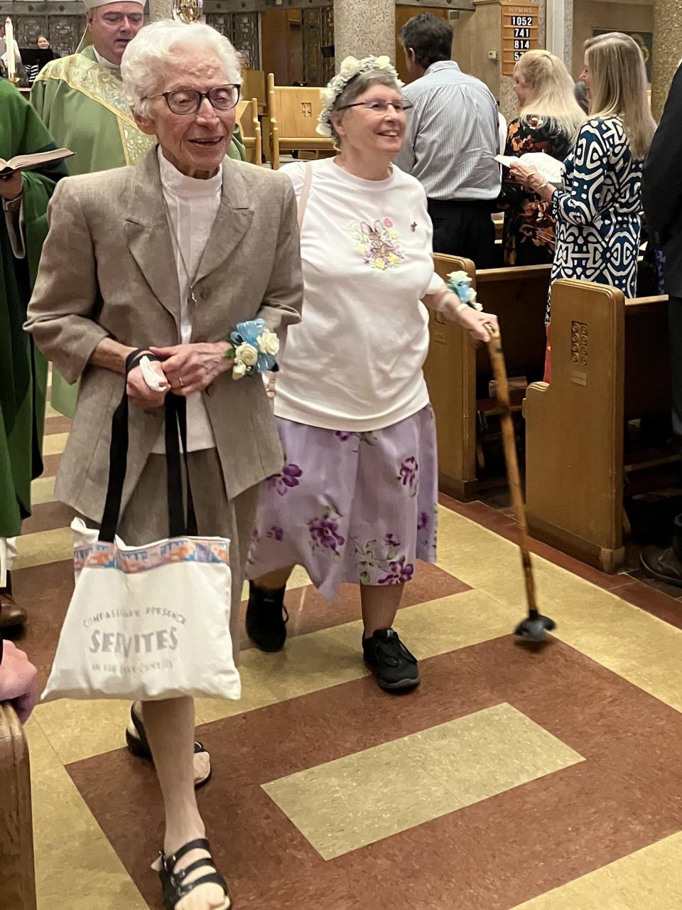 Sisters Mary Peter Caito, 86, (left) and Sr. Kathy Avery, 80, leave church smiling as they celebrate their farewell celebration at St. Clare Montefalco Catholic Church in Grosse Pointe Park. Avery and Caito, who dedicated 16 years of service to St. Clare's school, are leaving Michigan and headed back to their motherhouse in Omaha, Nebraska.
