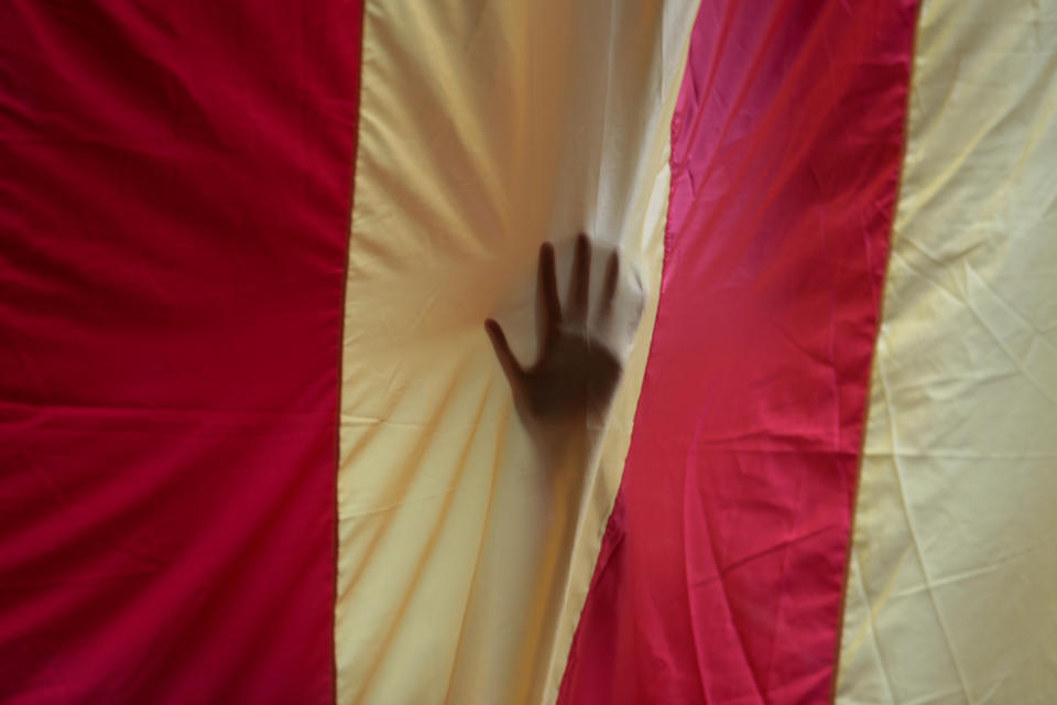 <p>A hand is seen through a giant Estelada (Catalan separatist flag) in the University of Barcelona’s historic building a day before the banned Oct. independence referendum in Barcelona, Spain, Sept. 30, 2017. (Photo: Enrique Calvo/Reuters) </p>