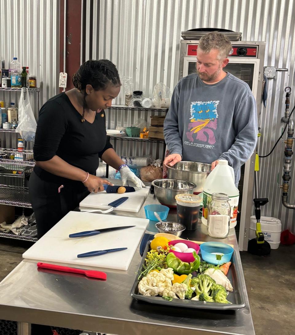 Jeremy Malanka (right) teaches a culinary course at DREAMS Center for Art Education in Wilmington.