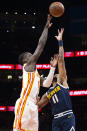 Atlanta Hawks forward AJ Griffin, left, shoots over Denver Nuggets forward Bruce Brown during the first half of an NBA basketball game Friday, Dec. 2, 2022, in Atlanta. (AP Photo/Hakim Wright Sr.)