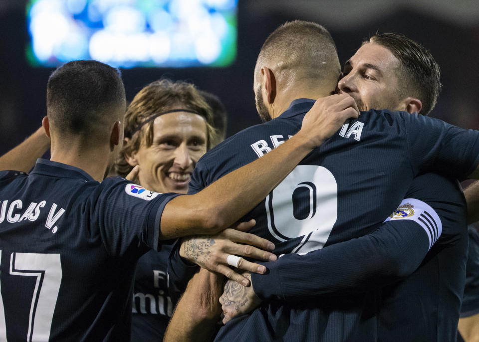 Real Madrid's Karim Benzema is congratulated by teammates after scoring a goal during a Spanish La Liga soccer match between RC Celta and Real Madrid at the Balaidos stadium in Vigo, Spain, Sunday, November 11, 2018. (AP Photo/Lalo R. Villar)