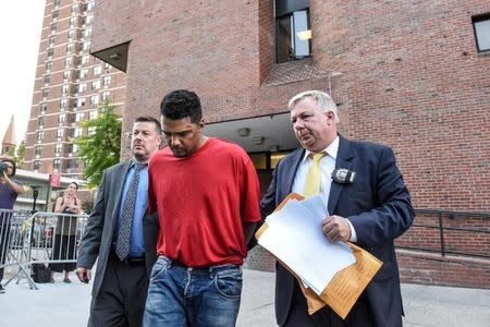 Richard Rojas is escorted from the 7th precinct by New York City Police officers after being processed in connection with the speeding vehicle that struck pedestrians on a sidewalk in Times Square in New York City, U.S., May 18, 2017. REUTERS/Stephanie Keith