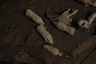 Mud covers water bottles on Friday, Aug. 5, 2022, in Fleming-Neon, Ky. (AP Photo/Brynn Anderson)