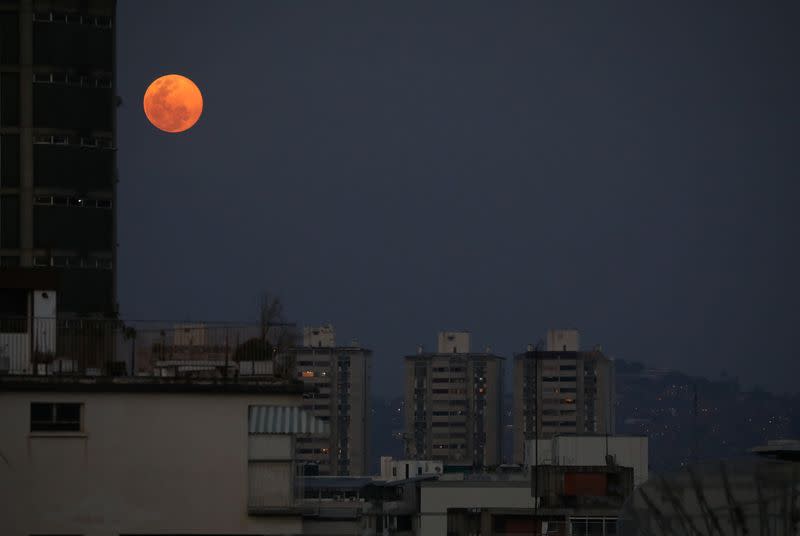 The Pink Supermoon rises the city of Caracas in an astronomical event that occurs when the moon is closest to the Earth in its orbit, making it appear much larger and brighter than usual, in Caracas