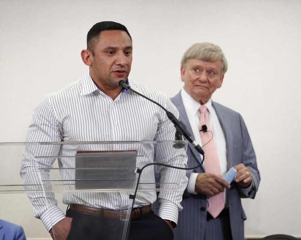 FILE - In this Jan. 26, 2021, file photo, Houston Police officer Felipe Gallegos speaks as lawyer Rusty Hardin listened during a press conference at Hilton Americas, in Houston. Gallegos, was indicted on Wednesday, July 23, 2021, in what prosecutors say are the final charges to be filed in a long running corruption probe following a 2019 Houston police drug raid in which a couple was killed. (Karen Warren/Houston Chronicle via AP, file)