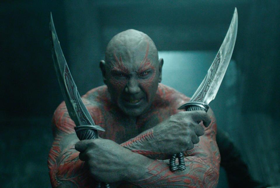 Drax holds two swords with his arms crossed