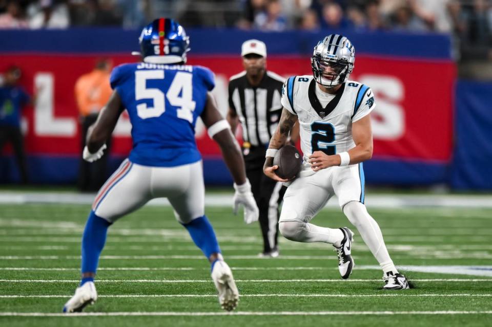 Carolina Panthers quarterback Matt Corral (2) tries to get past New York Giants linebacker Dyontae Johnson (54) during the third quarter at MetLife Stadium.