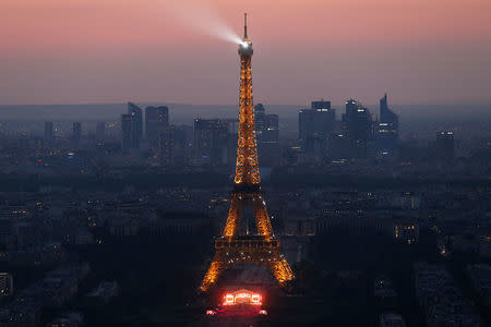 FILE PHOTO: The Eiffel Tower is lit up during an open air concert, in a picture taken from the Montparnasse Tower Observation Deck, at the end of Bastille Day events in Paris, France, July 14, 2018. REUTERS/Pascal Rossignol