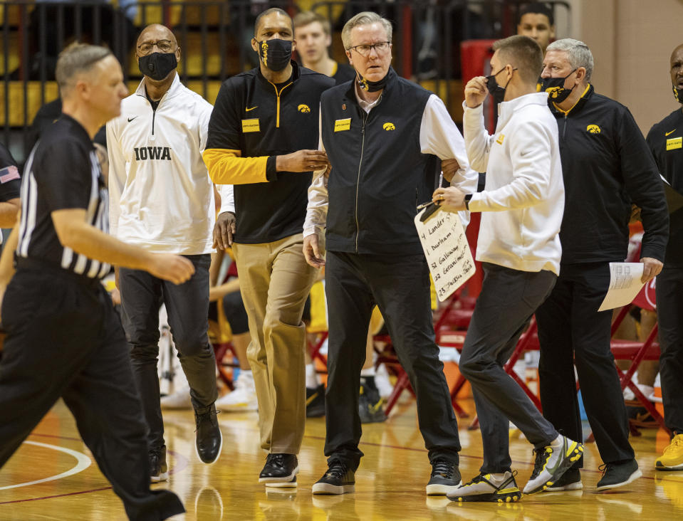 Iowa head coach Fran McCaffery is restrained by members of the team's staff after he was called for a technical foul during the first half of an NCAA college basketball game against Indiana, Sunday, Feb. 7, 2021, in Bloomington, Ind. (AP Photo/Doug McSchooler)