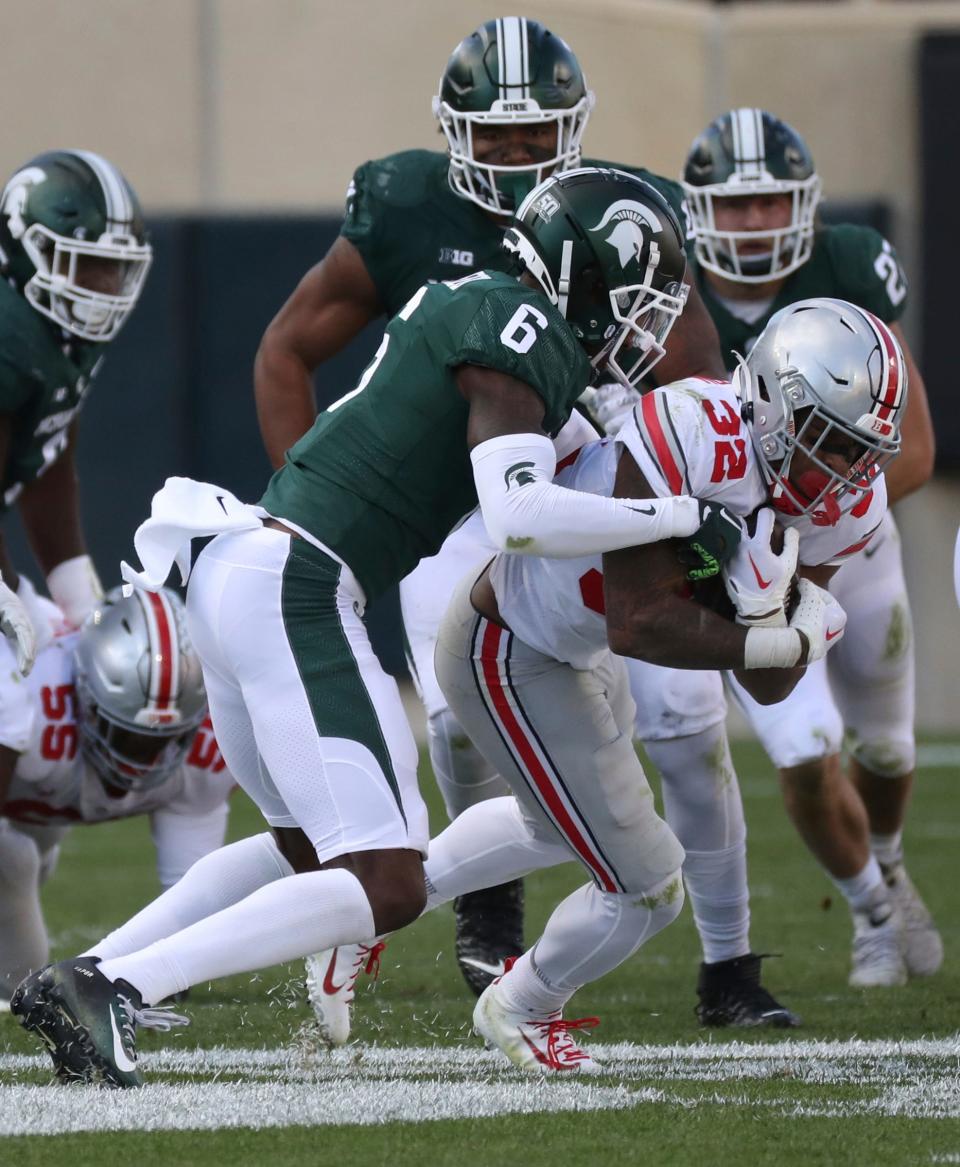Michigan State Spartans cornerback Ameer Speed (6) tackles Ohio State Buckeyes running back TreVeyon Henderson (32) during first half action at Spartan Stadium Saturday, October 8, 2022.