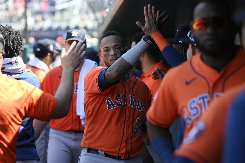 Houston Astros' Martin Maldonado celebrates his two-run home run in the dugout during the fifth inning of a baseball game against the Washington Nationals, Sunday, May 15, 2022, in Washington. (AP Photo/Nick Wass)