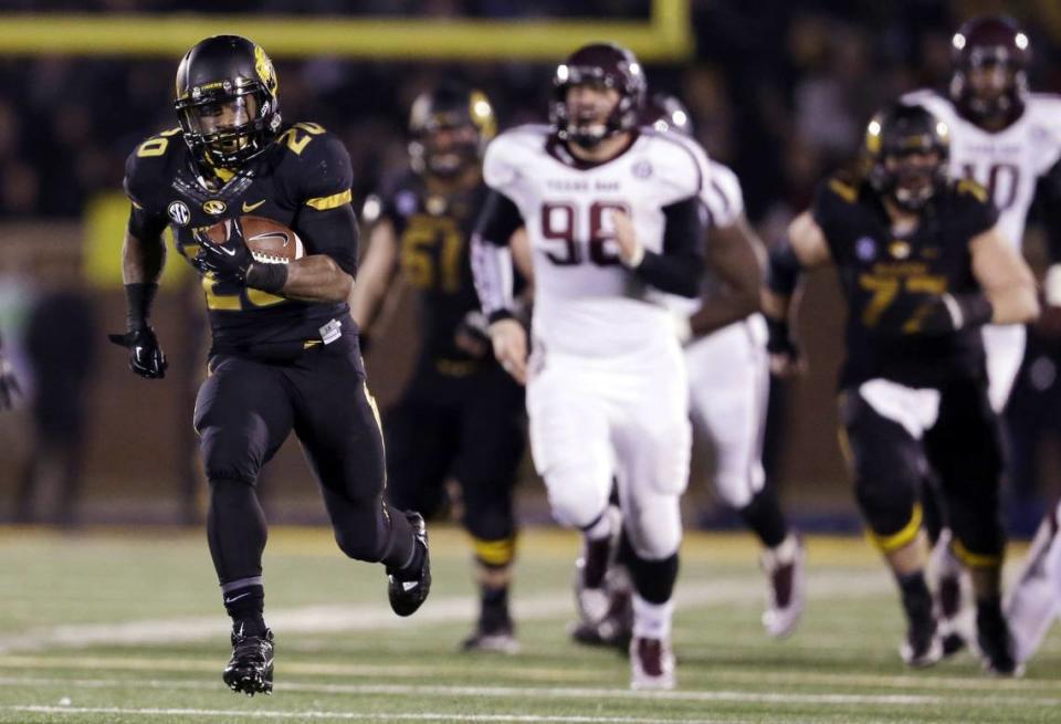Missouri running back Henry Josey, left, scores on a 57-yard touchdown run during the fourth quarter of an NCAA college football game against Texas A&M on Saturday, Nov. 30, 2013, in Columbia, Mo. (AP Photo/Jeff Roberson)