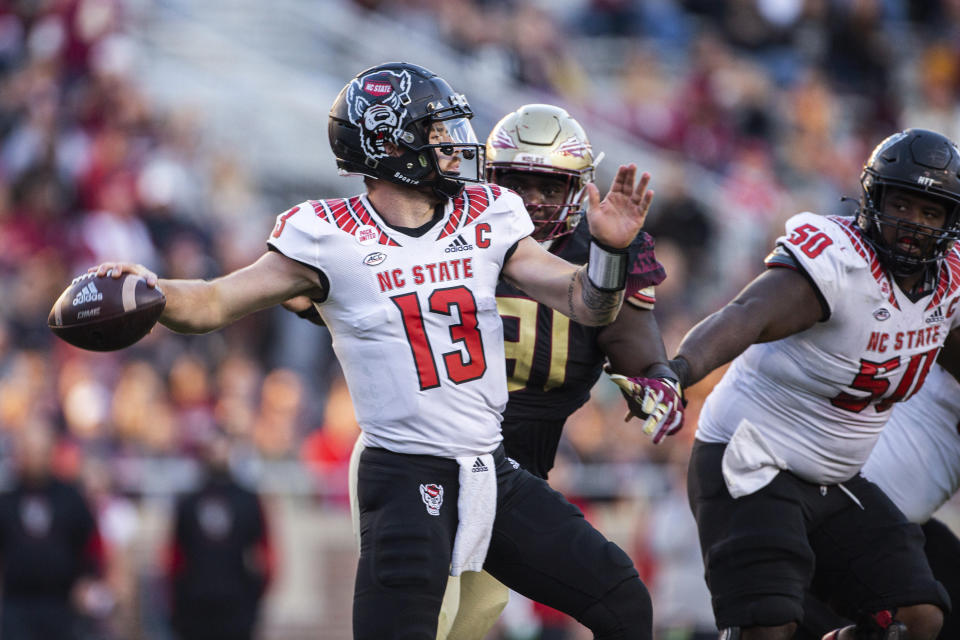 North Carolina State quarterback Devin Leary (13) looks for a receiver during the second half of the team's NCAA college football game against Florida State in Tallahassee, Fla., Saturday, Nov. 6, 2021. N.C. State won 28-14. (AP Photo/Mark Wallheiser)