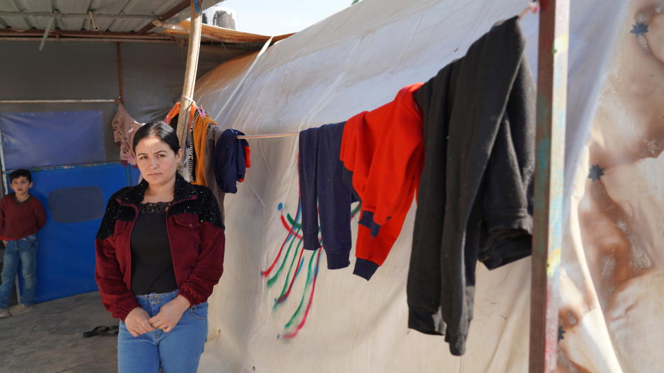 Zena Kalo, 30, speaks to The Associated Press at the tent that her family shares with her sister in law in Kabarto camp in northern Iraq’s Dohuk province on Saturday November 19, 2021. Kalo and her family returned to Iraq from Minsk Friday on a flight organized by the Iraqi government two months after they left for Belarus, driven by dreams of a new life in Europe.(AP Photo/Rashid Yahya)