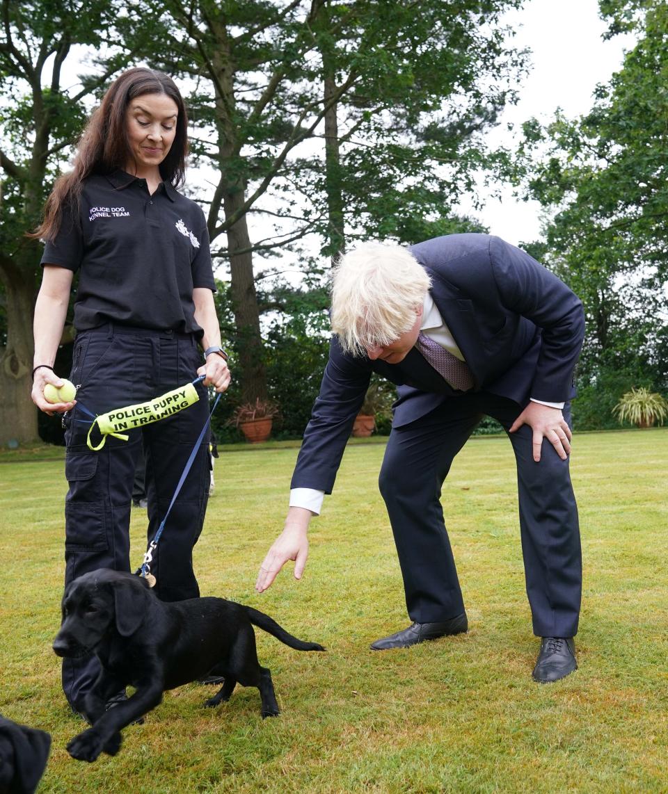 Prime Minister Boris Johnson speaks to police dog kennel staff during a visit to Surrey Police headquarters in Guildford, Surrey (Yui Mok/PA) (PA Wire)
