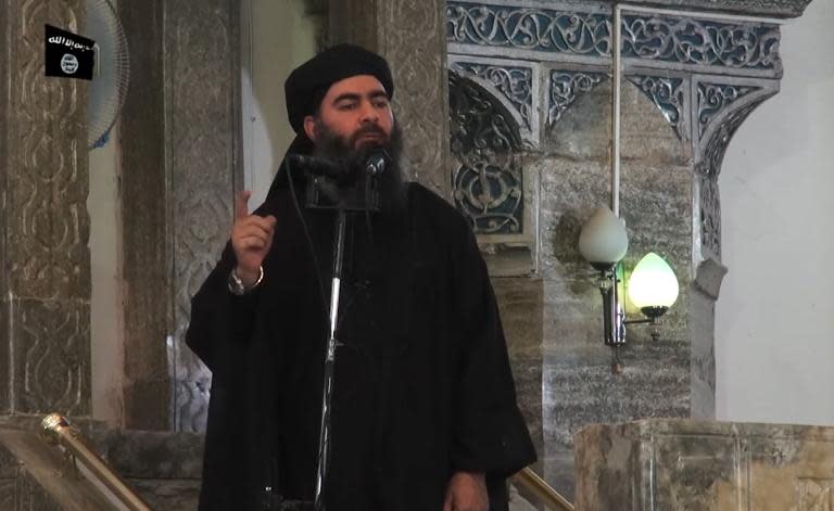 The leader of the Islamic State (IS) jihadist group, Abu Bakr al-Baghdadi, aka Caliph Ibrahim, adressing Muslim worshippers at a mosque in the militant-held northern Iraqi city of Mosul
