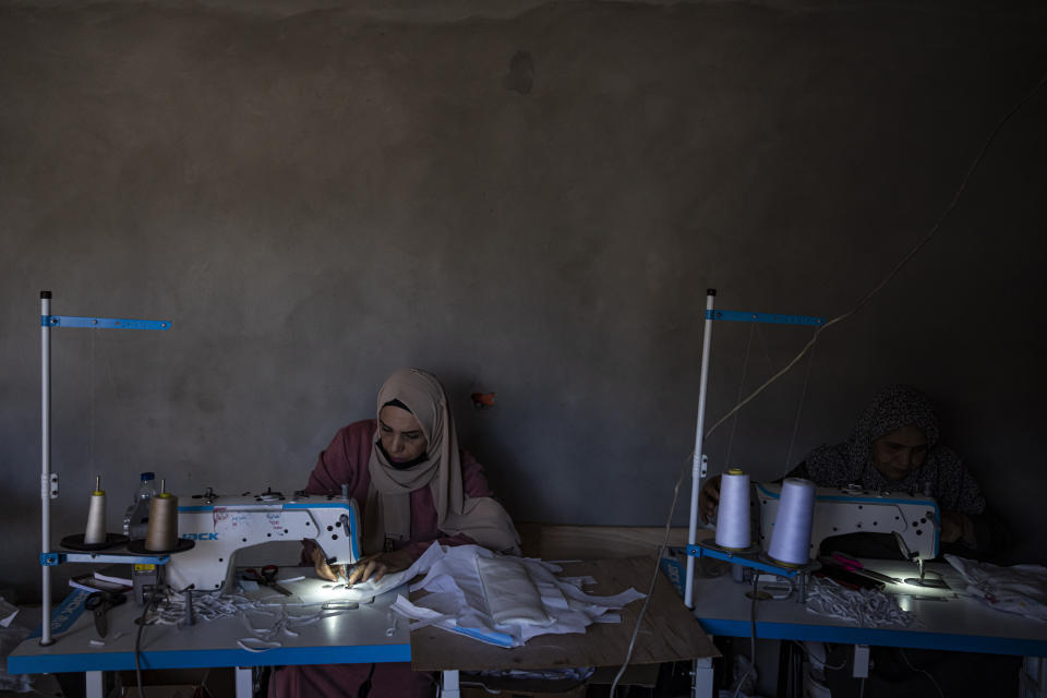 A Palestinian woman sews diapers in Rafah, southern Gaza Strip, Thursday, Feb. 15, 2024. Palestinians in Gaza have experienced severe shortages of basic necessities since the war began on Oct. 7. (AP Photo/Fatima Shbair)
