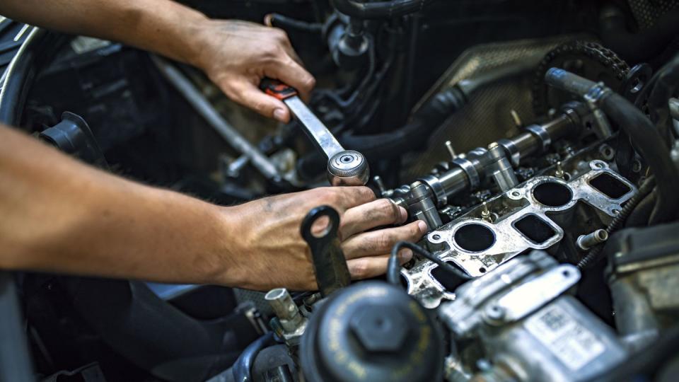 mechanic using a ratchet wrench