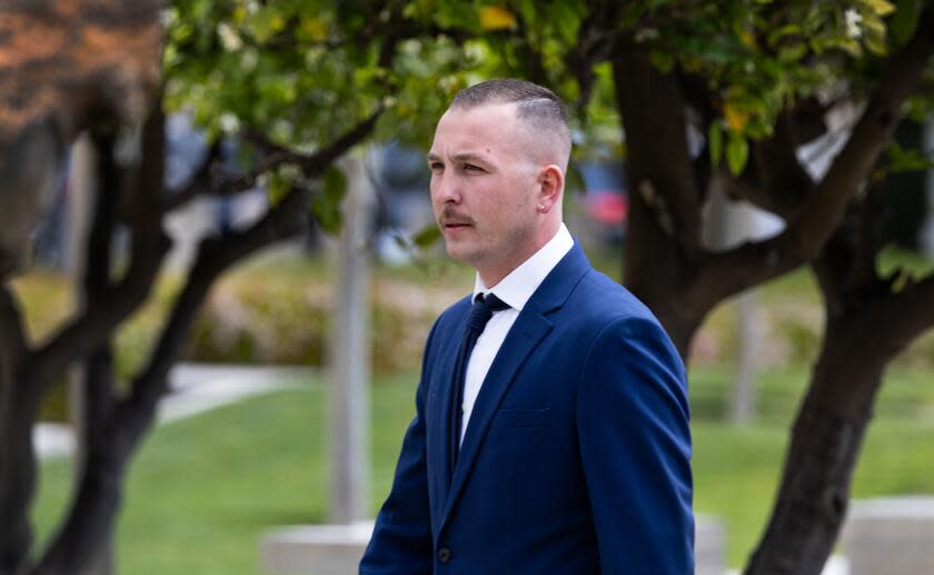 Santa Ana, CA - April 04: Tyler Laube, of Redondo Beach, walks to the entrance to the Ronald Reagan Federal Courthouse in Santa Ana Thursday, April 4, 2024. Laube pleaded guilty last year to a misdemeanor count of interference with a federally protected right without bodily injury. In a plea agreement, he admitted to repeatedly punching a journalist - identified only as F.T. - who was covering a rally in Huntington Bunch. (Allen J. Schaben / Los Angeles Times)