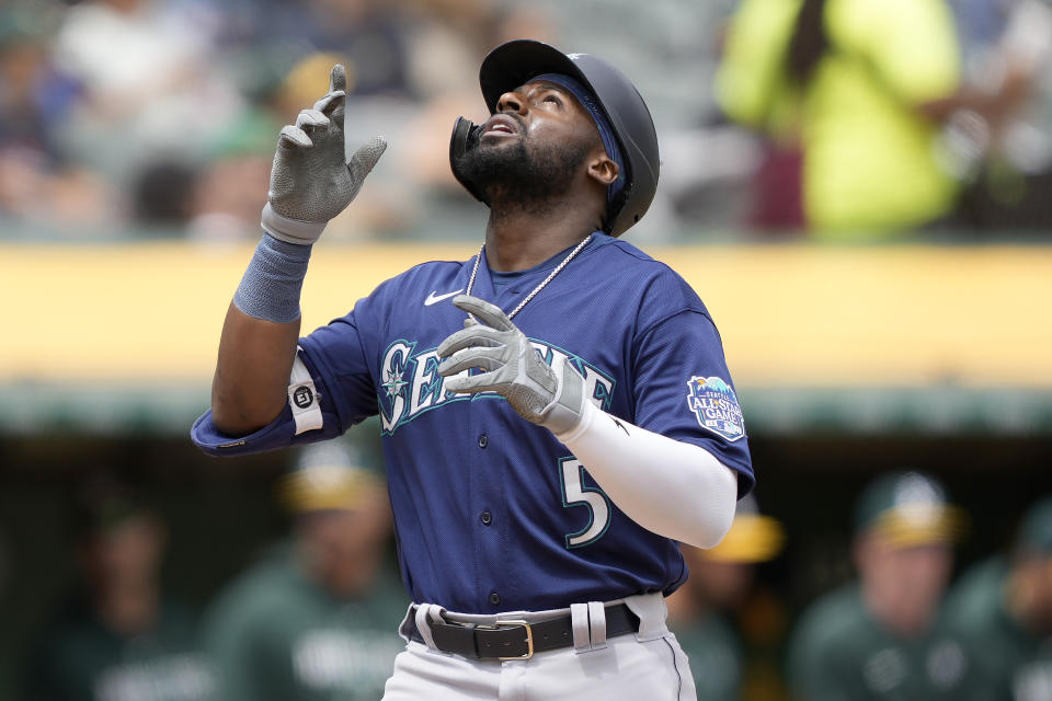 Seattle Mariners' Taylor Trammell (5) points to the sky as he crosses home plate after hitting a two-run home run during the third inning against the Oakland Athletics in a baseball game in Oakland, Calif., Thursday, May 4, 2023. (AP Photo/Tony Avelar)
