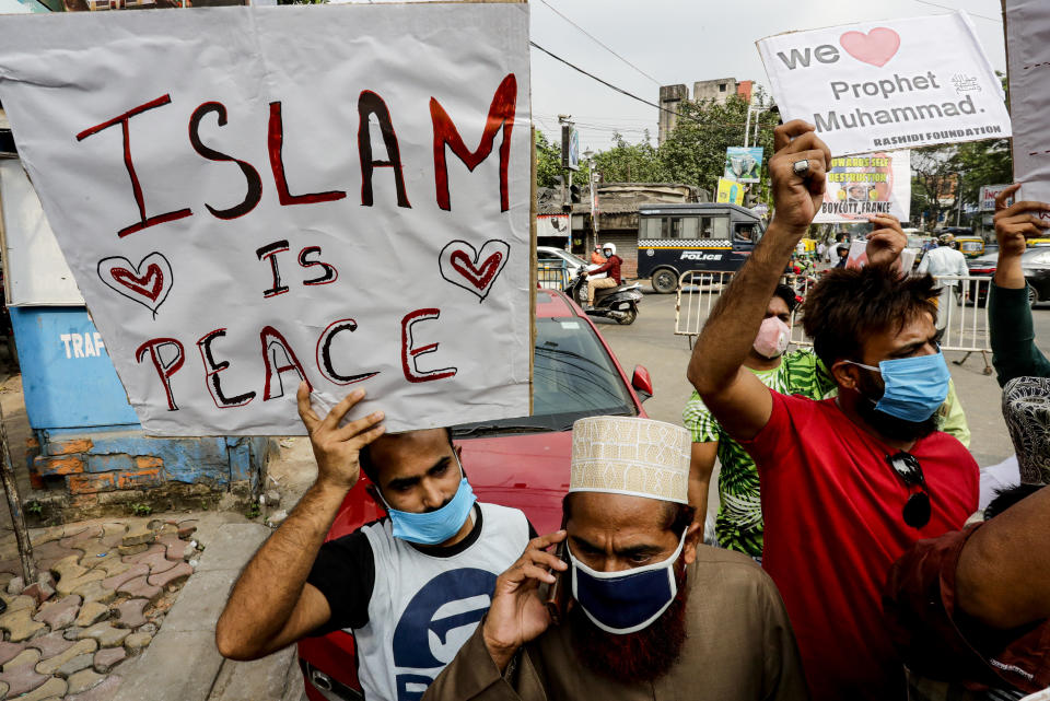Muslim activists from various organizations hold placards and participate in a protest against France, near the French Consulate, in Kolkata, India, Saturday, Oct. 31, 2020. Muslims have been calling for both protests and a boycott of French goods in response to France's stance on caricatures of Islam's most revered prophet. (AP Photo/Bikas Das)