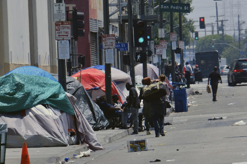 FILE - In this May 30, 2019 file photo, tents housing homeless line a street in downtown Los Angeles.The Los Angeles City Council has voted to ban homeless encampments within 500 feet of schools and daycare centers. The council voted Tuesday, Aug. 9, 2022, to broaden an existing ban on sleeping or camping near the facilities. (AP Photo/Richard Vogel, File)