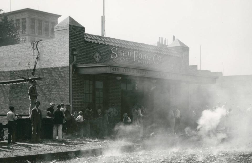 Smoke rises from firecrackers in front of Sheu Fong Co., which advertises eggs and poutry, in 1931 as the business celebrates its 10th year at 422 I Street, the current location of Sacramento’s Chinatown Mall.