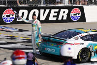 Denny Hamlin celebrates with the checkered flag after winning a NASCAR Cup Series auto race at Dover Motor Speedway, Sunday, April 28, 2024, in Dover, Del. (AP Photo/Derik Hamilton)