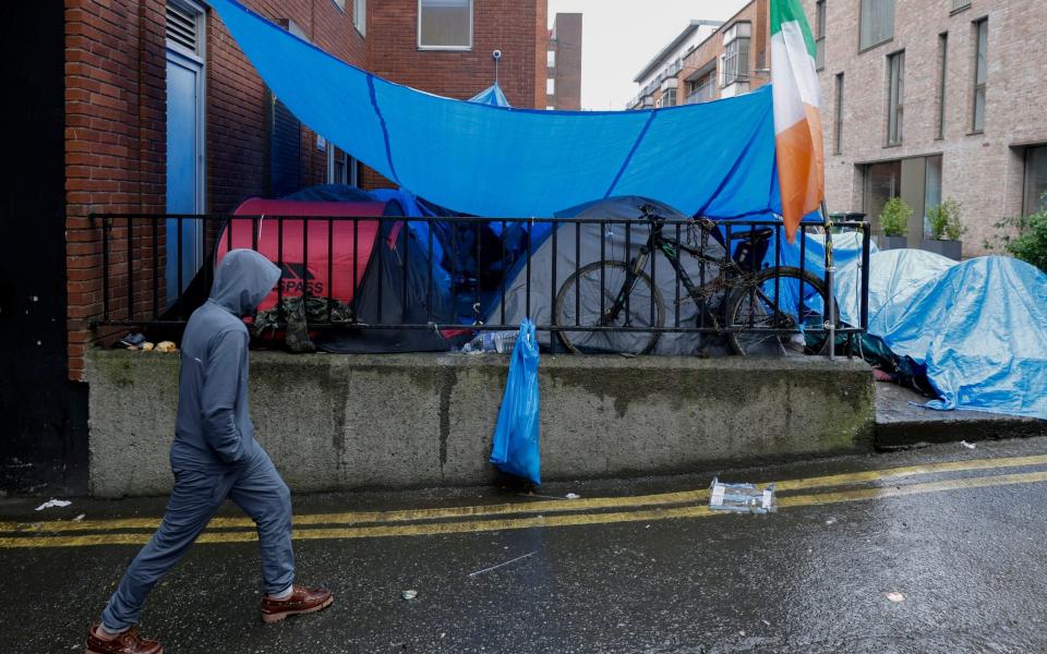 Many migrants have been here for months, living in leaky red tents draped in weathered blue tarpaulin sheets